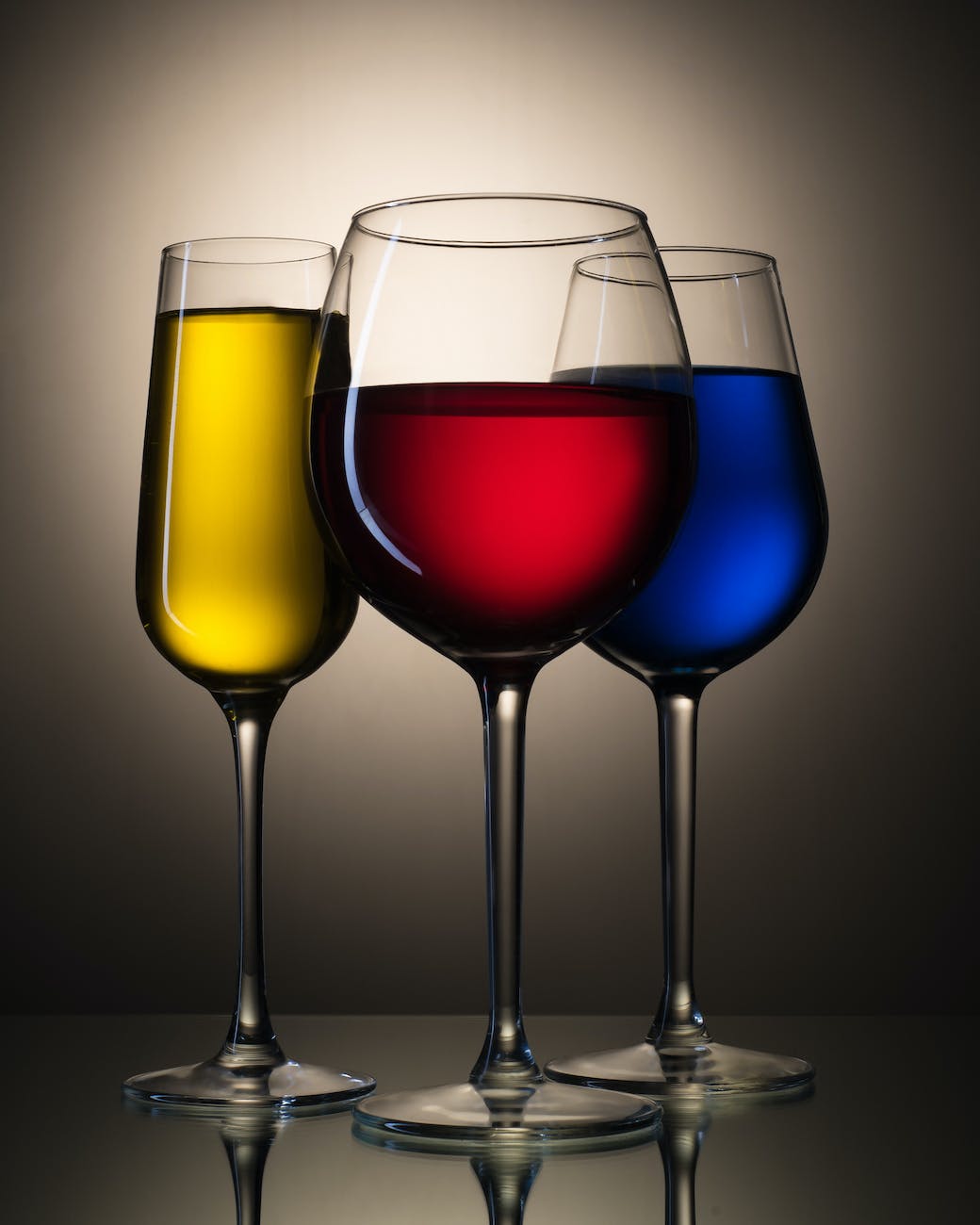 different types of bar glasses with colored liquids